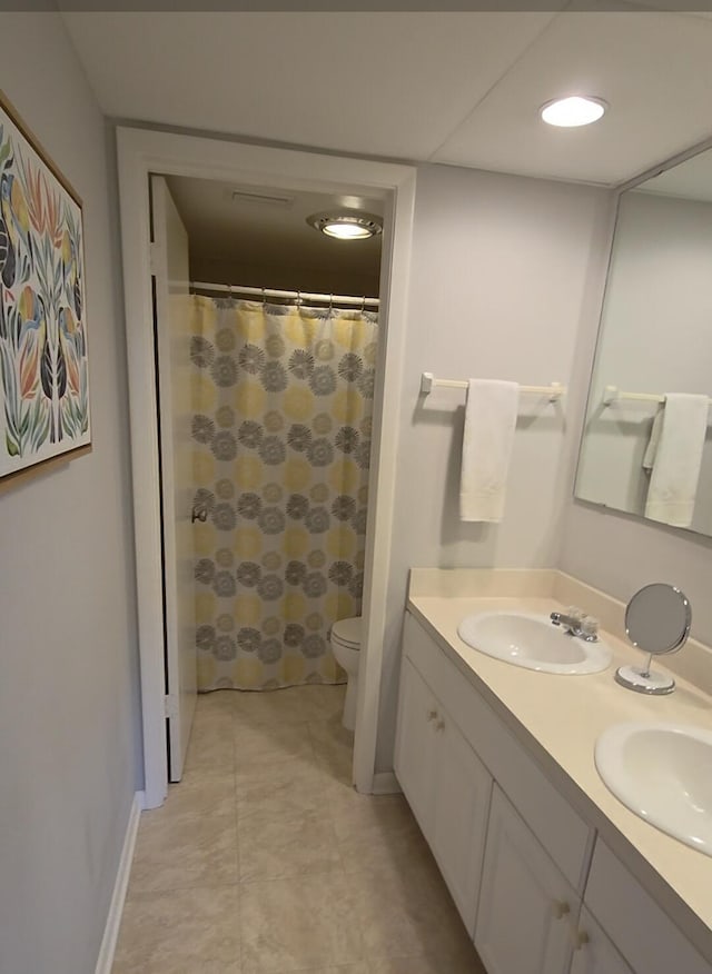 1854 SW Palm City Rd Unit 101, Stuart, FL 34994 - bathroom featuring double vanity, toilet, tile patterned flooring, and curtained shower