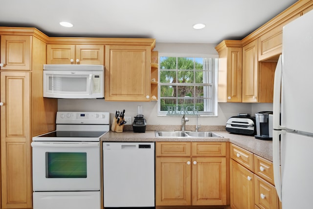 kitchen featuring light brown cabinetry, sink, and white appliances