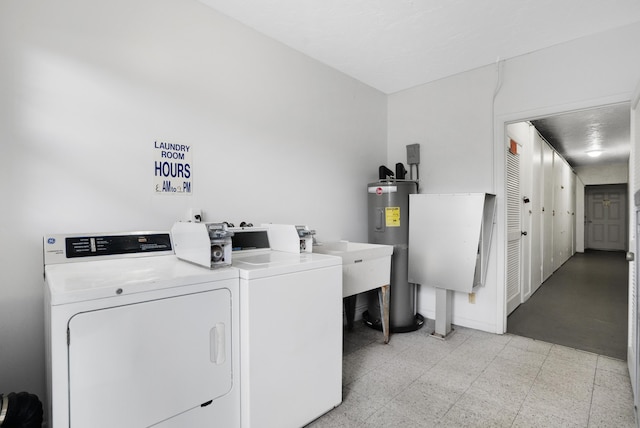 1854 SW Palm City Rd Unit 101, Stuart, FL 34994 - laundry room with a sink, independent washer and dryer, water heater, and light floors