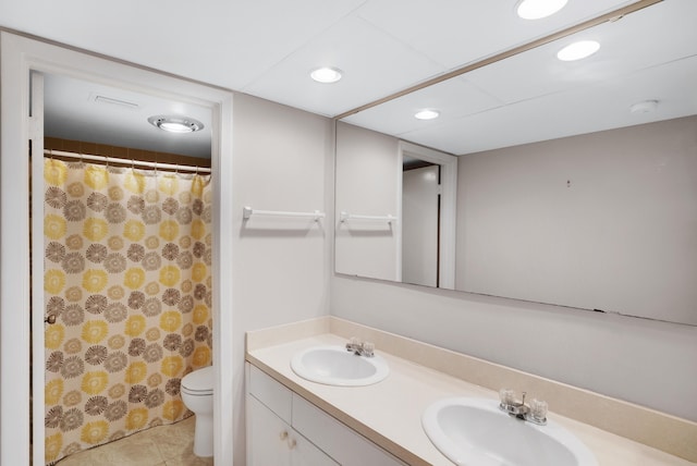 bathroom with tile patterned floors, curtained shower, vanity, and toilet