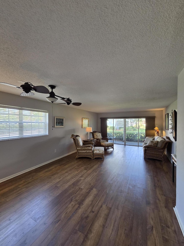 1854 SW Palm City Rd Unit 101, Stuart, FL 34994 - living room with a textured ceiling, dark wood finished floors, healthy amount of natural light, and ceiling fan