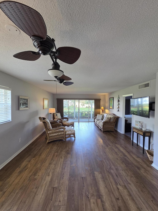1854 SW Palm City Rd Unit 101, Stuart, FL 34994 - living area with a textured ceiling, ceiling fan, and dark wood-style floors