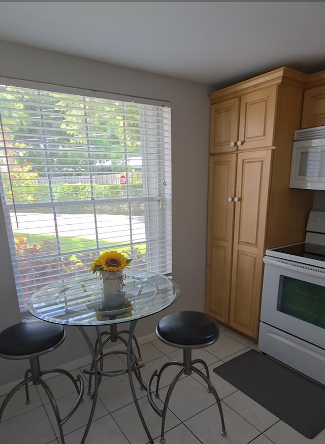 1854 SW Palm City Rd Unit 101, Stuart, FL 34994 - kitchen with white appliances, plenty of natural light, and light tile patterned floors