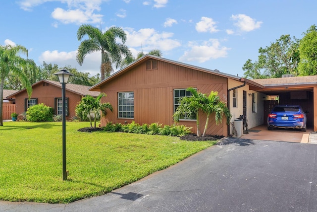 single story home with a carport and a front lawn