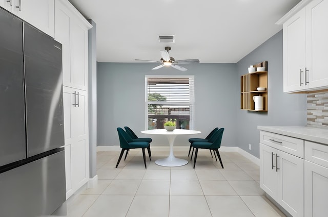 tiled dining area featuring ceiling fan