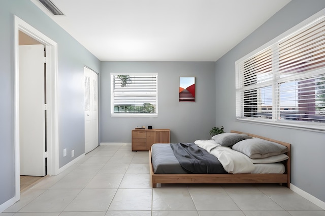 tiled bedroom with a closet