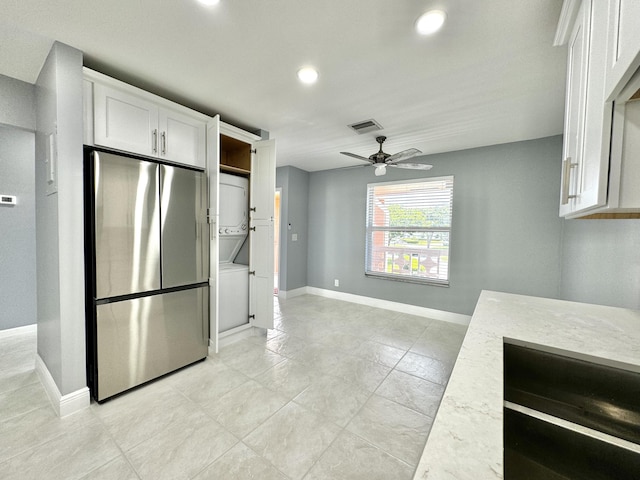 kitchen featuring white cabinetry, stainless steel fridge, light stone countertops, and ceiling fan