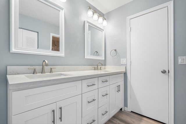 bathroom with hardwood / wood-style floors and vanity