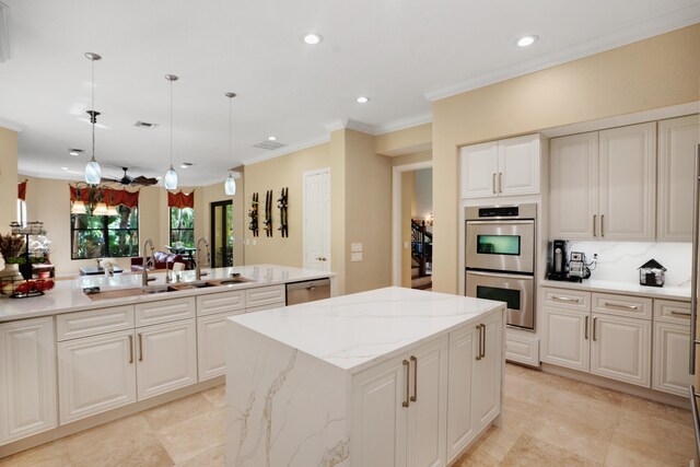 kitchen with a center island, ornamental molding, appliances with stainless steel finishes, pendant lighting, and light stone countertops