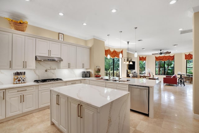 kitchen with decorative light fixtures, a center island, ornamental molding, kitchen peninsula, and stainless steel appliances