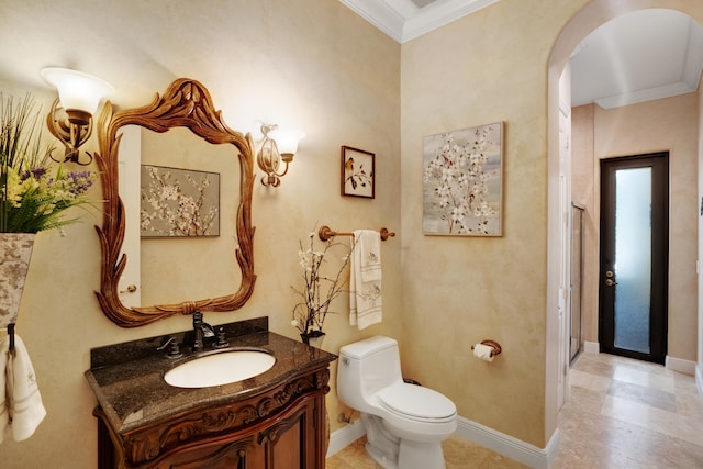 bathroom with vanity, crown molding, and toilet