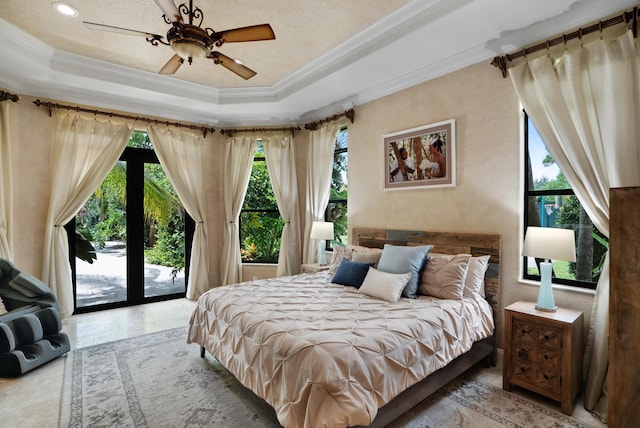 bedroom featuring access to exterior, ornamental molding, a raised ceiling, and ceiling fan