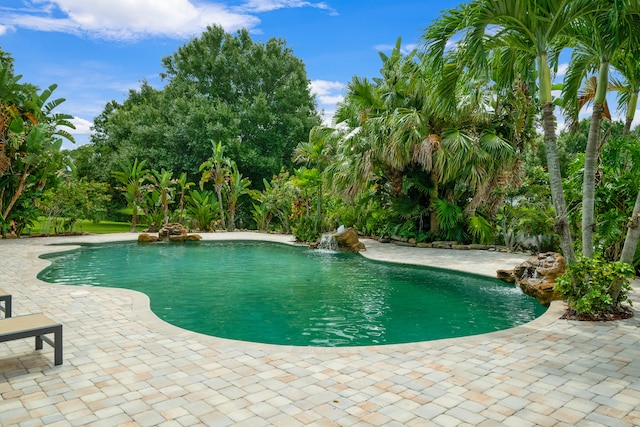 view of pool featuring pool water feature and a patio area