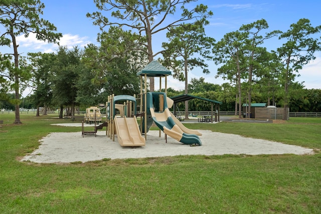 view of jungle gym featuring a lawn