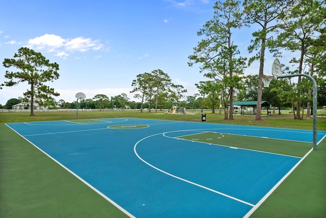 view of basketball court with a playground