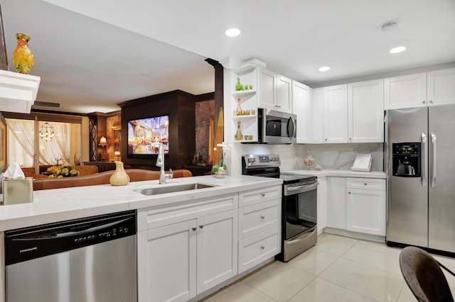 kitchen featuring stainless steel appliances, white cabinetry, sink, and light tile patterned flooring