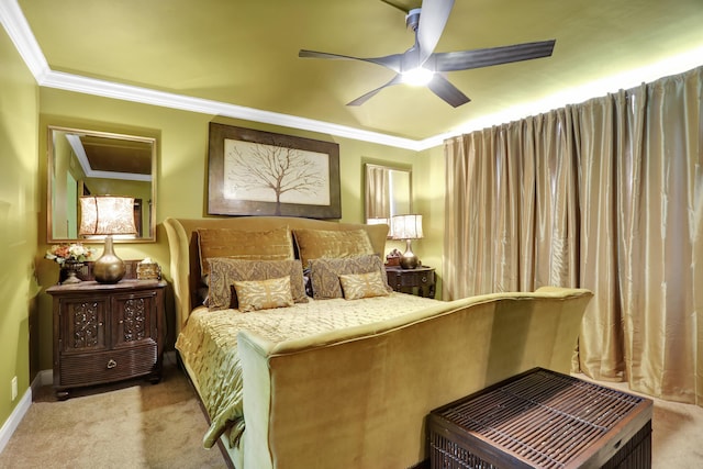 carpeted bedroom with ornamental molding and ceiling fan