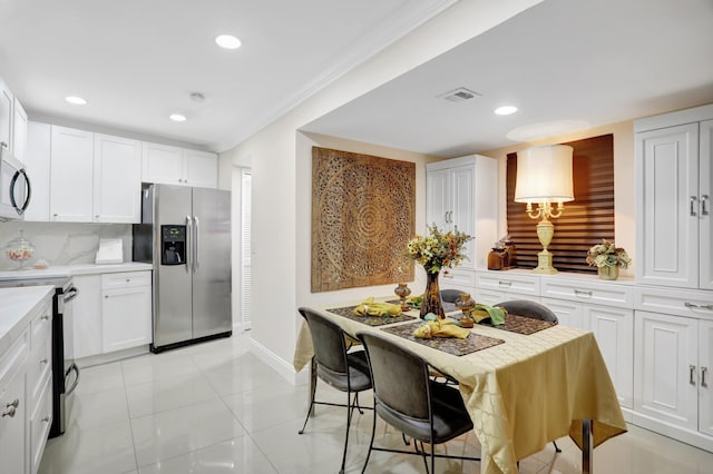 kitchen featuring stainless steel fridge, electric range oven, backsplash, ornamental molding, and white cabinets