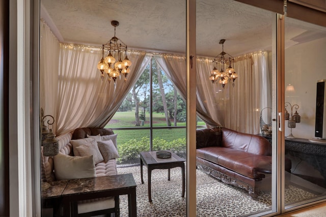 sitting room featuring a textured ceiling and a notable chandelier