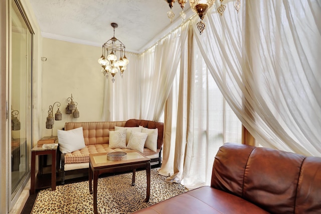 living area featuring a textured ceiling and a chandelier