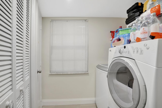 clothes washing area featuring independent washer and dryer