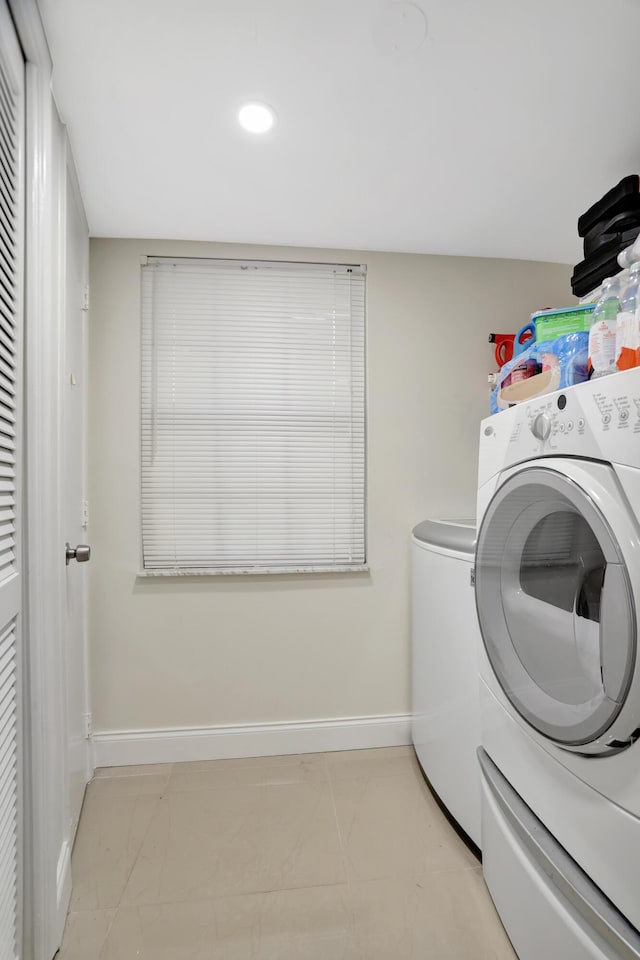 clothes washing area featuring washing machine and clothes dryer