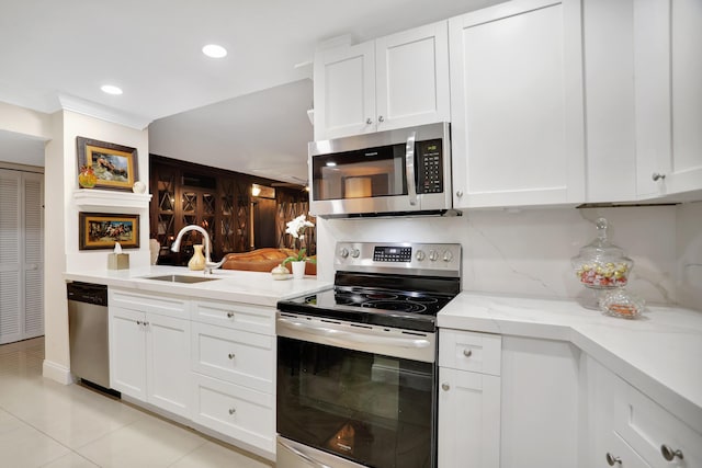 kitchen with white cabinetry, appliances with stainless steel finishes, and sink