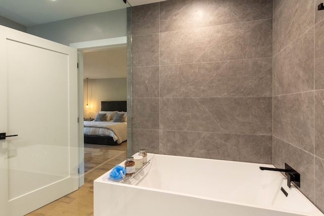 bathroom featuring hardwood / wood-style floors and a bathtub