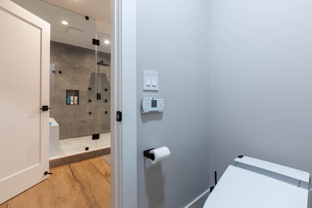 bathroom featuring walk in shower and hardwood / wood-style flooring