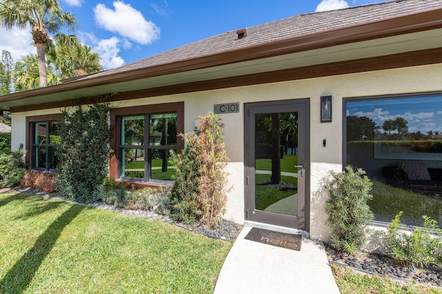 property entrance with a yard