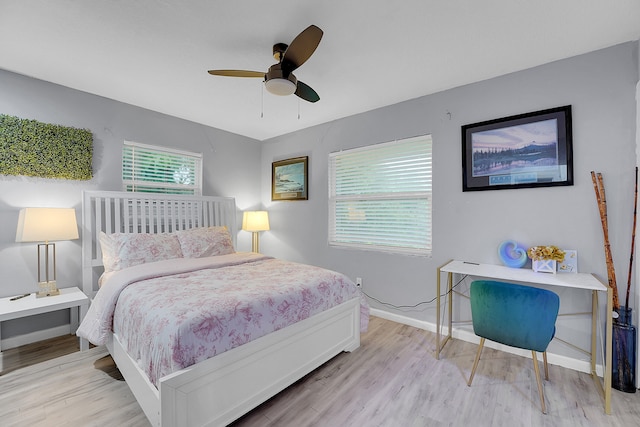 bedroom with ceiling fan and light hardwood / wood-style flooring