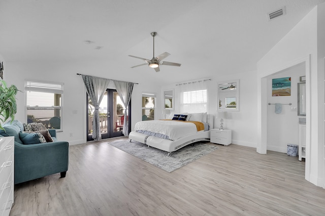 bedroom featuring access to exterior, vaulted ceiling, ceiling fan, and light wood-type flooring