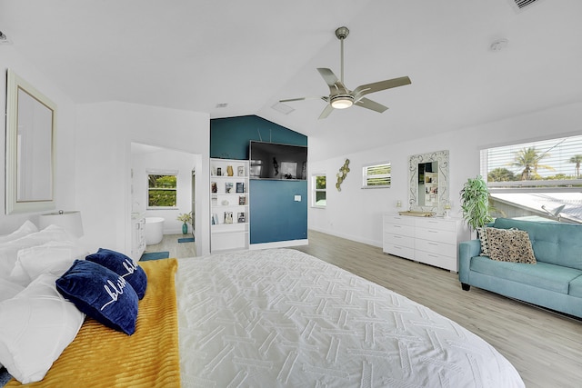 bedroom with lofted ceiling, hardwood / wood-style floors, multiple windows, and ceiling fan