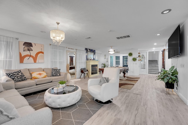 living room featuring an inviting chandelier and wood-type flooring