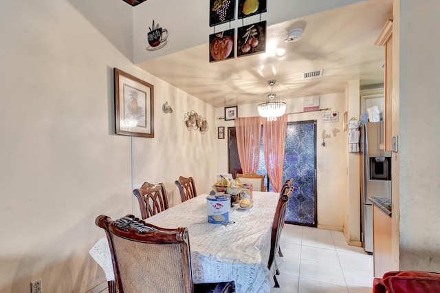 dining area with a notable chandelier and light tile patterned floors