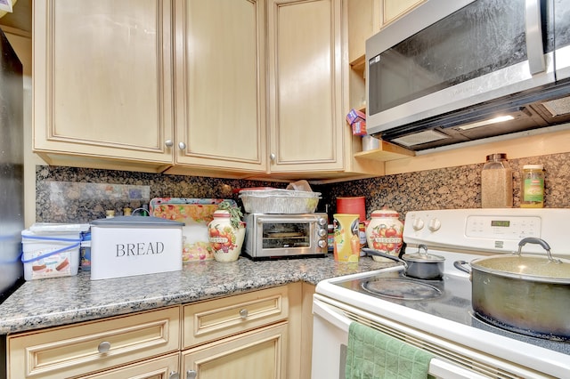 kitchen with light brown cabinetry and white electric stove