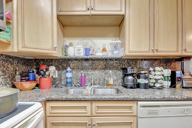 kitchen featuring sink, white dishwasher, light stone countertops, and stove