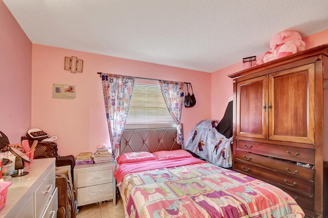 tiled bedroom with a textured ceiling