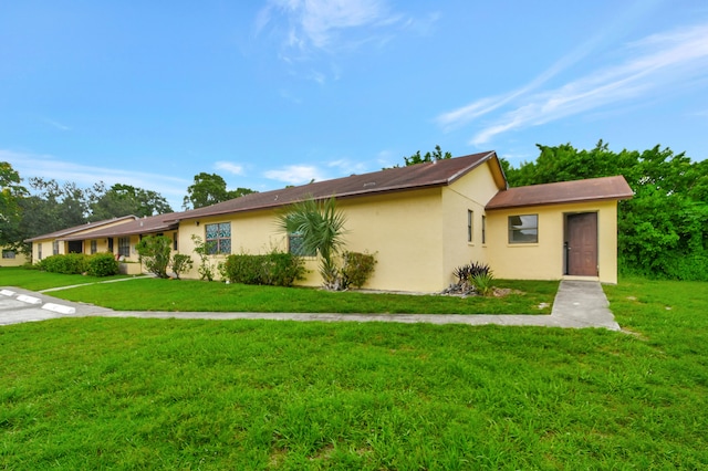 ranch-style house with a front lawn