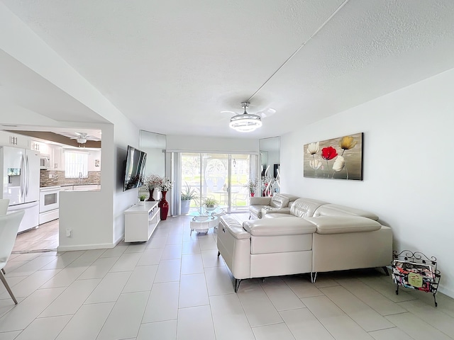 kitchen featuring sink, light stone counters, white appliances, decorative backsplash, and white cabinets