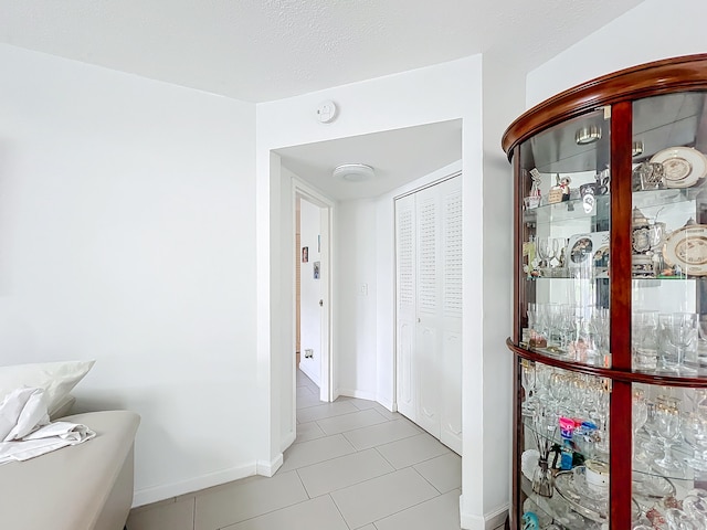 hall featuring light tile patterned flooring