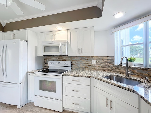 kitchen featuring backsplash, white cabinetry, sink, and white appliances