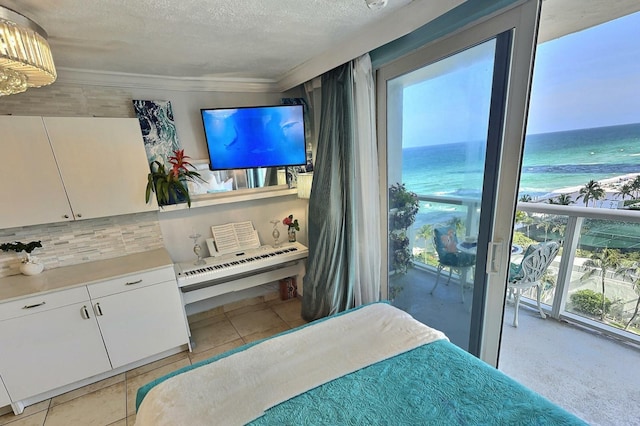 bedroom with light tile patterned flooring and a textured ceiling