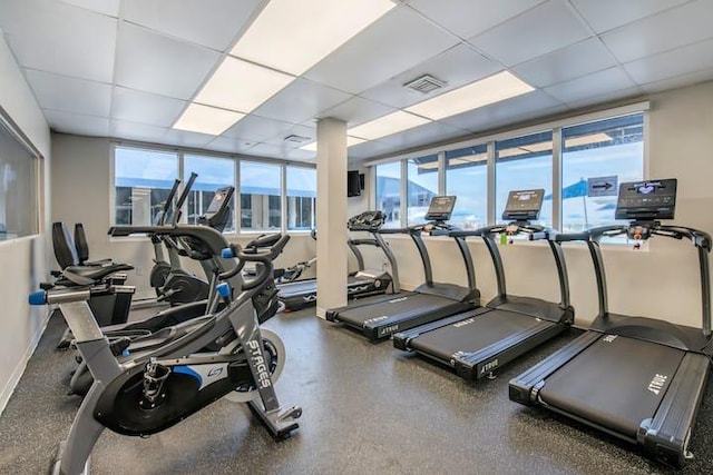 exercise room with a paneled ceiling