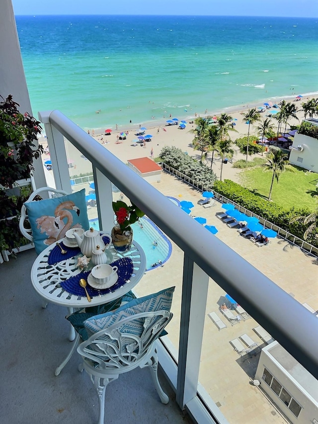 balcony with a water view and a beach view