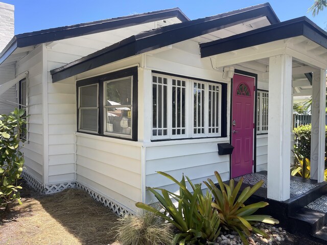 bungalow-style home featuring a front yard