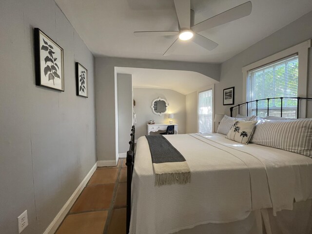 kitchen featuring white appliances, decorative light fixtures, a peninsula, light brown cabinets, and a sink