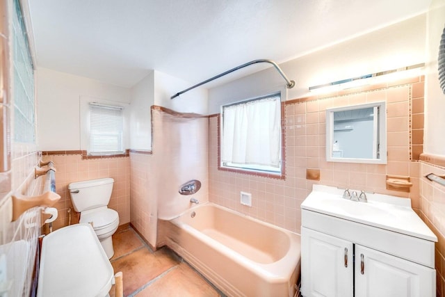 full bath featuring toilet, shower / bath combination, vanity, tile walls, and tile patterned floors