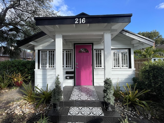 doorway to property featuring fence