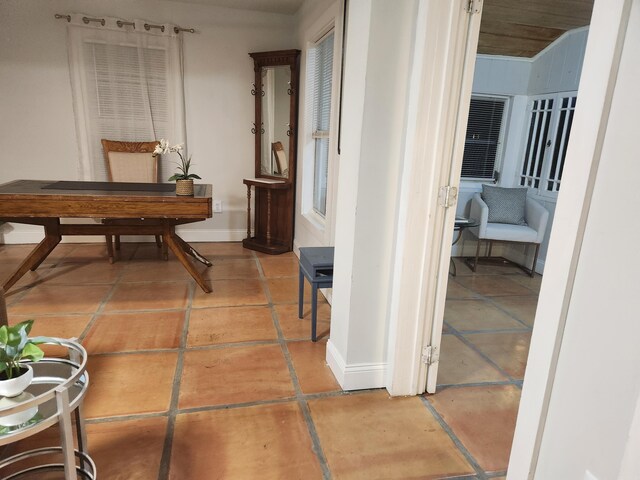 living room with visible vents, baseboards, and light tile patterned floors